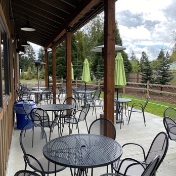 Johnson's Smokehouse - a patio with tables and umbrellas - Smokehouse Near Me - Olympia, Washington