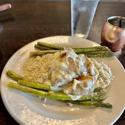 Boathouse Restaurant - Stuffed Brie and apple chicken served on top of a bed of rice and grilled asparagus