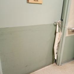 Upper East Side Rehabilitation and Nursing Center - Wad of clean bibs (will be used by patients). Propping open "Day Room" door. Sun, June 9, 2024