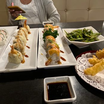 Ohana Sushi - a woman sitting at a table with plates of sushi - Japanese Near Me - Riverside, California Ohana Sushi - a woman sitting at a table with plates of sushi - Japanese Near Me - Riverside, California