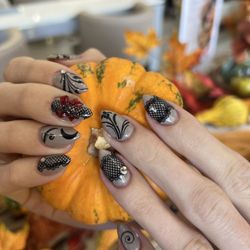 Golden File Nail Spa - Smoky grey base with chic black witch-inspired nail art.