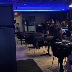 Legacy Resturant & Lounge - Servers just chillin smoking hookah while we all sit and wait