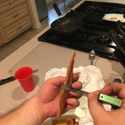 a person cutting a piece of bacon a person cutting a piece of bacon