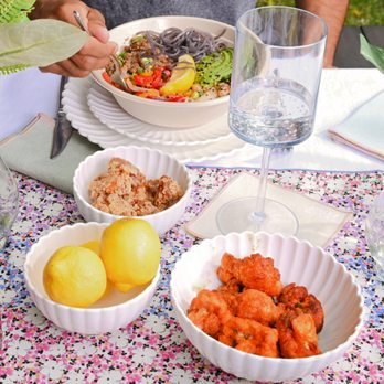 moonbowls - a person sitting at a table with bowls of food - Korean Near Me - San Francisco, California moonbowls - a person sitting at a table with bowls of food - Korean Near Me - San Francisco, California