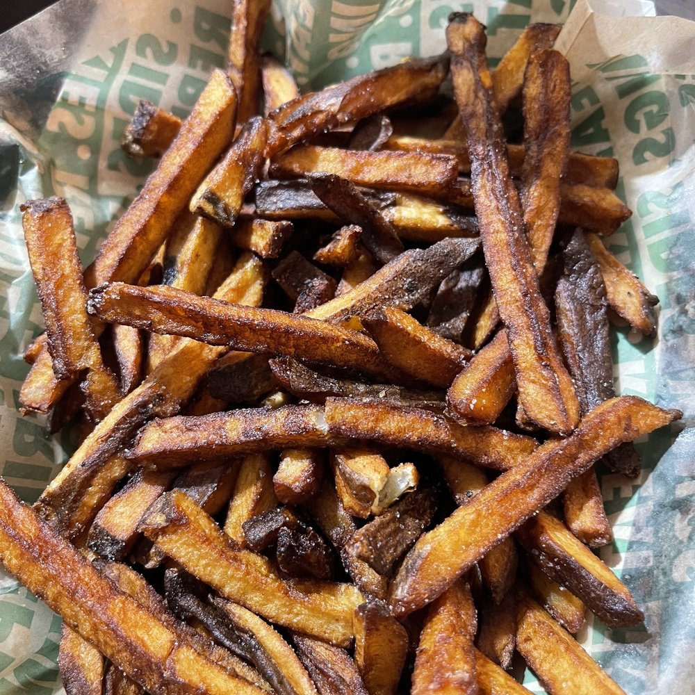 Wingstop - a basket of french fries on a table - Chicken Wings Near Me - Los Banos, California Wingstop - a basket of french fries on a table - Chicken Wings Near Me - Los Banos, California
