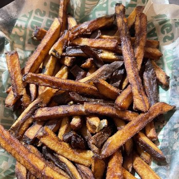Wingstop - a basket of french fries on a table - Chicken Wings Near Me - Los Banos, California Wingstop - a basket of french fries on a table - Chicken Wings Near Me - Los Banos, California