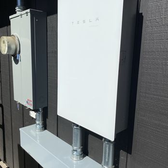 Comletric - New house power and Tesla Gateway installation - A Tesla Gateway electrical enclosure is installed on an exterior wall, connected with conduit to a smaller electrical box. - Electricians Near Me - Concord, California