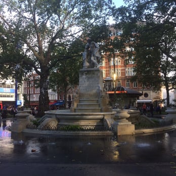 Leicester Square - There's a fountain that you can sit beside because you've realized you're too early for the show at Leicester Square theater - Landmarks & Historical Buildings Near Me