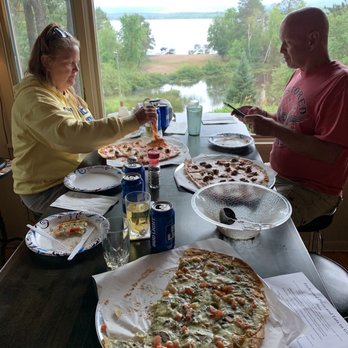 The Enchanted Inn - a man and a woman eating pizza - Italian Near Me - Gordon, Wisconsin