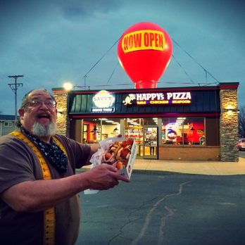 Savvy Sliders - a man holding a hot dog - Burgers Near Me - Melvindale, Michigan