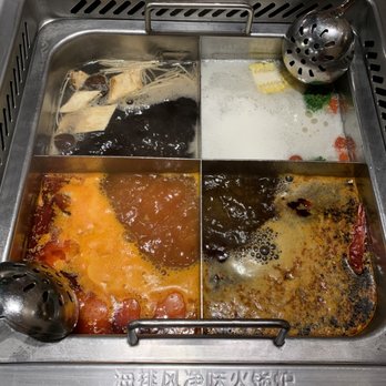 Haidilao Hotpot Flushing - Left to right Mushroom broth, pork bone broth, tomato broth, mala broth - Hot Pot Near Me - Flushing, New York Haidilao Hotpot Flushing - Left to right Mushroom broth, pork bone broth, tomato broth, mala broth - Hot Pot Near Me - Flushing, New York