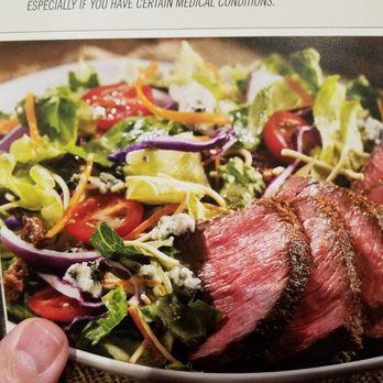 Outback Steakhouse - Menu picture of mixed greens but you will get just iceberg lettuce. - Steakhouses Near Me - Southaven, Mississippi Outback Steakhouse - Menu picture of mixed greens but you will get just iceberg lettuce. - Steakhouses Near Me - Southaven, Mississippi