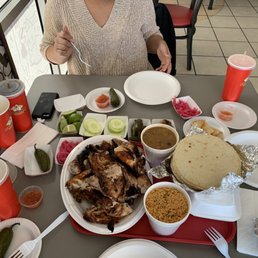 a woman sitting at a table full of food a woman sitting at a table full of food