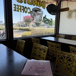 Best Donut House - Box of  to go. Bright yellow chair inside