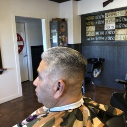 City Limits Classic Barbershop - Mid fade shear work up top.