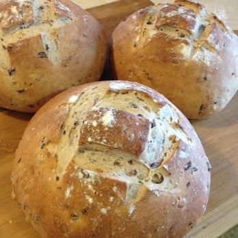 All Crumbs Artisan Bakery - four loaves on a cutting board - Bakeries Near Me - Toledo, Ohio