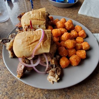 Biscuit & Hogs - The Pig Feed in the back and the Prime Steak Sandwich with sweet potato tots. - New American Near Me - Meridian, Idaho