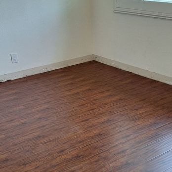 Lam's Flooring - New wood floor before reinstalling base board. - Flooring Near Me