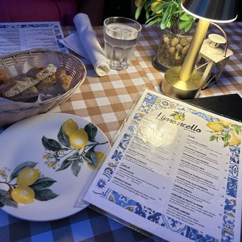 Limoncello - Garlic bread complimentary and menu. Geraldo was an amazing server - Italian Near Me - Miami Beach, Florida