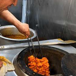 Fresh Chicken Boti being prepared in the traditional tandoor at MashaAllah Halal Food in San Francisco.