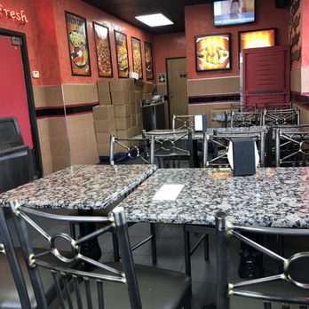 Happy's Pizza - tables and chairs in a restaurant - Pizza Near Me - Southfield, Michigan