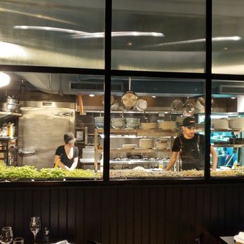 Île Flottante - Kitchen view from table in the dining room - French Near Me - Montreal, Quebec Île Flottante - Kitchen view from table in the dining room - French Near Me - Montreal, Quebec