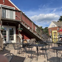 a patio area with tables and chairs