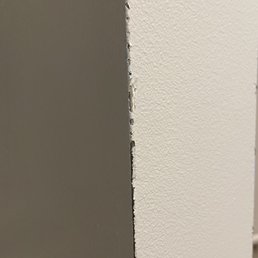 Several layers of paint rubbed down to the metal on the corners of walls.