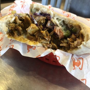 Naf Naf Grill - Half eaten...but packed with chicken. - Middle Eastern Near Me - Oakbrook Terrace, Illinois