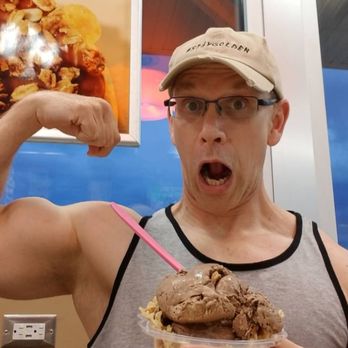 Baskin-Robbins - a man holding a doughnut in front of a poster - Ice Cream & Frozen Yogurt Near Me - Hopewell, Virginia Baskin-Robbins - a man holding a doughnut in front of a poster - Ice Cream & Frozen Yogurt Near Me - Hopewell, Virginia