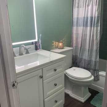 Courteous Colors - Bathroom remodel. Complete new vanity set, new mirror, new flooring,  new baseboards with a complete repaint on walls, trim and baseboards! - Painters Near Me
