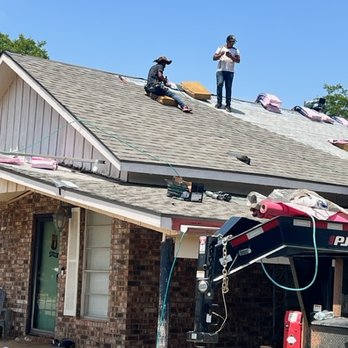 Gates Roofing & Construction - two men working on a roof - General Contractors Near Me