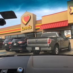 a couple of trucks parked in front of a store