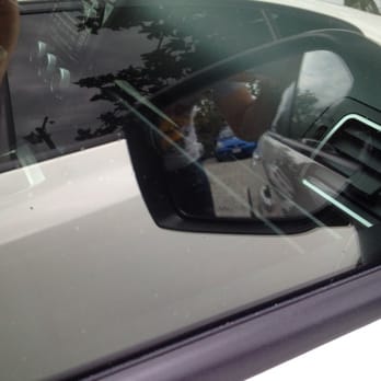 Chuys Mobile Window Tint - Another angle of dust trapped near side view mirror.  The air bubbles from the tint are already sealed up, this is just dust. - Car Window Tinting Near Me - Bakersfield, California