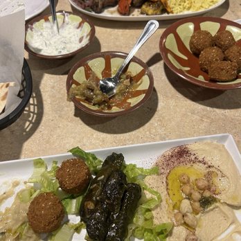 Sido's - Vegetarian Platter in the front. falafel in the middle along with eggplant dip and tzatziki sauce. The back is the mixed grill platter. - Mediterranean Near Me - Overland Park, Kansas Sido's - Vegetarian Platter in the front. falafel in the middle along with eggplant dip and tzatziki sauce. The back is the mixed grill platter. - Mediterranean Near Me - Overland Park, Kansas
