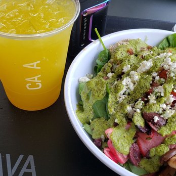 CAVA - A ginger fruit juice beverage, and a "super greens and grains" bowl, with mini pita. - Mediterranean Near Me - Cary, North Carolina