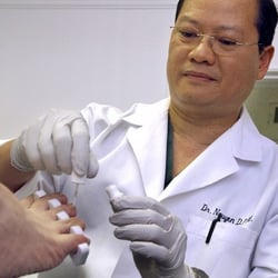 Tim Nguyen, DPM - Dr. Tim Nguyen applying Renewed Nail on a patient. (Photo from the Ventura County Star)