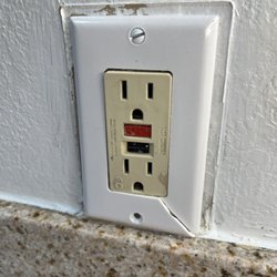 Holiday Inn & Suites Slidell - New Orleans Area - Cracked GFI cover in bathroom.