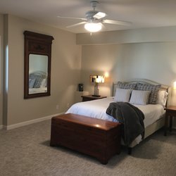 Frontier Kitchens and Interiors - Downstairs guest room After - replaced carpet and repainted walls/trim. Updated ceiling fan light fixture