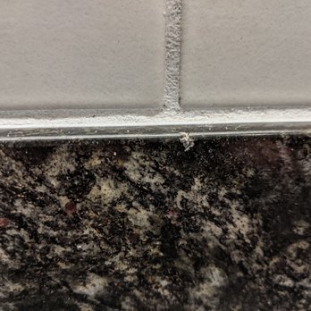 Dayla Soul Tile Installation - example of one of the many small chips in the granite backsplash - Tiling Near Me Dayla Soul Tile Installation - example of one of the many small chips in the granite backsplash - Tiling Near Me
