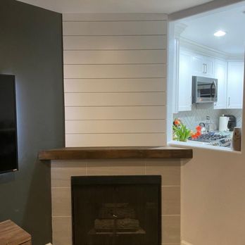 101 Group Remodeling - a fireplace in a living room - Tiling Near Me 101 Group Remodeling - a fireplace in a living room - Tiling Near Me