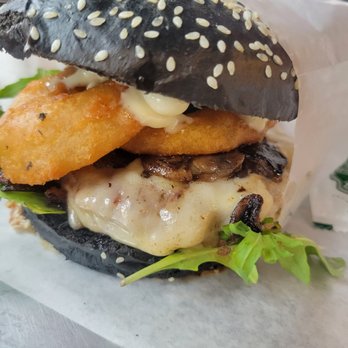 Meat The Bun - THEQUEEN Handcrafted 5oz Beef Puck, MTB Black Bun, Truffle infused Mushroom , Smoked Gouda Cheese,  Truffle Aioli, Crispy Onion Rings - Burgers Near Me - Edmonton, Alberta