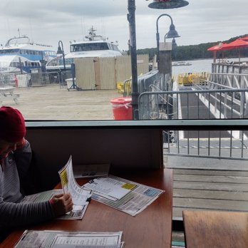 Fish House Grill - a man sitting at a table reading a newspaper - Seafood Near Me - Bar Harbor, Maine