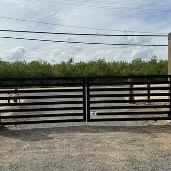 Valley Entry Systems - Go swing gates with two 6006 actuator arms view from inside of property facing road - Fences & Gates Near Me - Riverbank, California Valley Entry Systems - Go swing gates with two 6006 actuator arms view from inside of property facing road - Fences & Gates Near Me - Riverbank, California