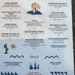 Menu is simple but enough - A menu from The Moonstone restaurant in Tucson, AZ, includes sections for burgers, chicken, tacos, salads, nachos, and desserts. It features illustrations of a cactus, mountains, and a sun, with a central cactus and sun graphic. The menu lists dishes such as birria burger, Sonoran chicken wrap, and elotes cheesy bread, with prices ranging from $6 to $16. The restaurant's address, 930 E 2nd St, Tucson, AZ 85719, is printed at the bottom. Decorative elements include stylized mountains, a cactus, and a small flower, all in a blue and brown color scheme. The menu emphasizes Southwestern cuisine and includes a disclaimer about food safety.