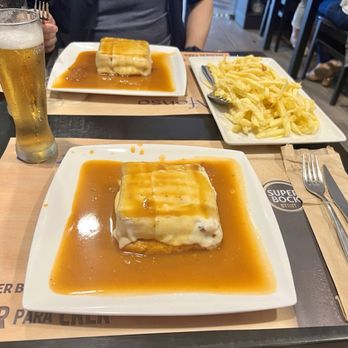O Afonso - Two different types of francesinhas. Our server said this pairs well with Super Bock (local beer) and encouraged us to order a glass of beer - Portuguese Near Me - Porto, 13