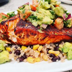 Justin’s Poolside Grill - Chili lime smoked salmon on bed of cauliflower rice , beans and corn. Topped with chunky guacamole.