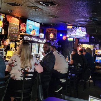 The Jimani - a group of people sitting at a bar watching televisions - Sports Bars Near Me - New Orleans, Louisiana The Jimani - a group of people sitting at a bar watching televisions - Sports Bars Near Me - New Orleans, Louisiana