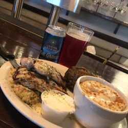 M Mogger's Restaurant & Pub - Grilled chicken smothered in a cheesy mushroom sauce , served over rice and your choice of sides .