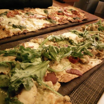 Seasons 52 - Flatbreads: All-natural Pepperoni on the left and Grilled Garlic Pesto Chicken on the right. - New American Near Me - Houston, Texas